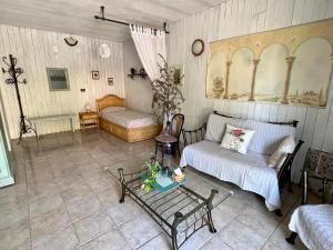 a living room with a couch and a table at B&b La Baronata - Pescosansonesco (Pe) in Pescosansonesco