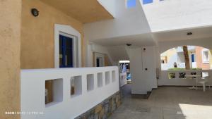 a hallway of a house with a white wall at Niros Beachfront Aparthotel in Kokkíni Khánion