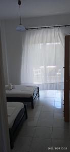 Postel nebo postele na pokoji v ubytování Lemonis House