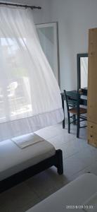 Postel nebo postele na pokoji v ubytování Lemonis House