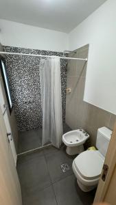 a small bathroom with a toilet and a shower at Casa Carlos Paz, 6 personas in Estancia Vieja