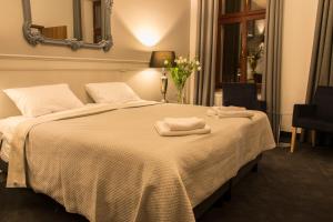 Postel nebo postele na pokoji v ubytování Hotel Retro B.A. Zientarski