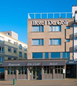 
a large building with a sign on the side of it at Hotel De Golf in Bredene

