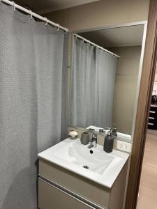 a bathroom with a sink and a large mirror at Solares de araus, apartamento in Colonia del Sacramento +8 photos
