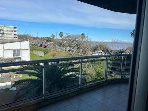a balcony with a view of the ocean at Solares de araus, apartamento in Colonia del Sacramento