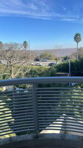 a metal bench with a view of a park at Solares de araus, apartamento in Colonia del Sacramento +8 photos