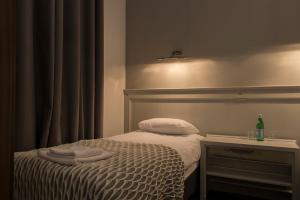 Postel nebo postele na pokoji v ubytování Hotel Retro B.A. Zientarski
