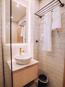 a white bathroom with a sink and a mirror at Villa Pupin Gorna Porta in Ohrid +91 photos
