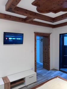 a living room with a flat screen tv on the wall at ROYAL RACiING SUITE TOP 4 in Judenburg