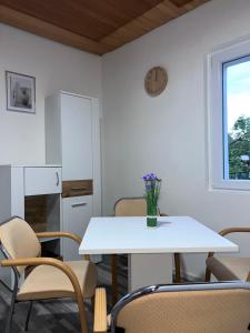 a kitchen with a white table and chairs at ROYAL RACiING SUITE TOP 4 in Judenburg