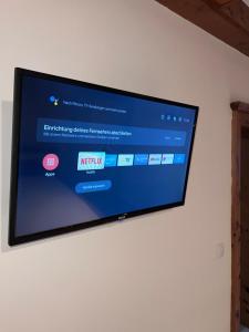 a flat screen tv hanging on a wall at Royal Racing Suite Top 4 near Red Bull Ring in Judenburg +5 photos