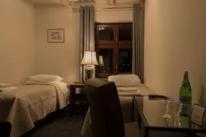 Postel nebo postele na pokoji v ubytování Hotel Retro B.A. Zientarski