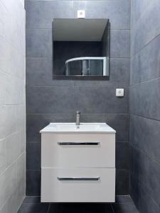 a bathroom with a white sink and a mirror at Royal Racing Suite Top 4 near Red Bull Ring in Judenburg