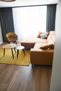 a living room with a couch and a chair at Misia Łapa in Grywałd