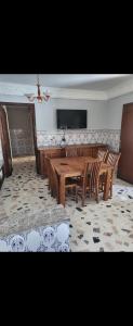 a dining room with a wooden table and chairs at Campagne in Tangier