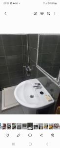 a bathroom with a white sink and a mirror at Campagne in Tangier +9 photos