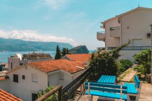 a blue bench sitting on the side of a building at Apartmani Čupić in Budva