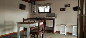a kitchen with a counter and a table and a sink at Los Ceibos Suites in Villa Ciudad de America +15 photos