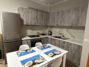 a kitchen with a table with a cross on it at Adrian Apartment in Orikum