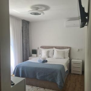 a bedroom with a bed with a blue blanket at Villa Queen in Zadar