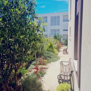 two benches sitting on a sidewalk next to a building at Villa Queen in Zadar +15 photos