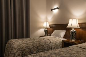 Postel nebo postele na pokoji v ubytování Hotel Retro B.A. Zientarski