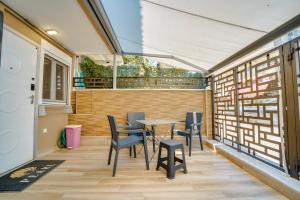 a patio with a table and chairs on it at Diamond & Pearl Studios in Perea