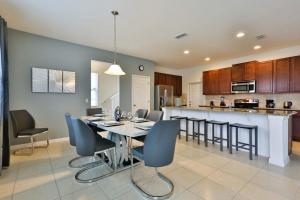 a dining room and kitchen with a table and chairs at Sruthan Kerith in Davenport
