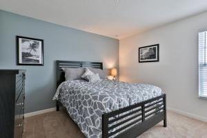 a bedroom with a bed with a gray and white bedspread at Sruthan Kerith in Davenport