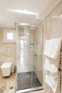 a bathroom with a shower and a toilet at Diamond & Pearl Studios in Perea +76 photos