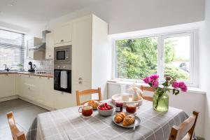 a kitchen with a table with food and flowers on it at Heather View in Haworth