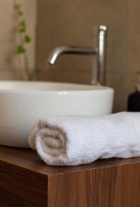 a white towel on a counter next to a sink at Domus Taura civico 48 in Terracina +15 photos