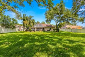 a yard with a house and a fence at Quiet and Cozy 3 beds 3 baths in Spring Hill with heated Pool and Hot Tub in Spring Hill