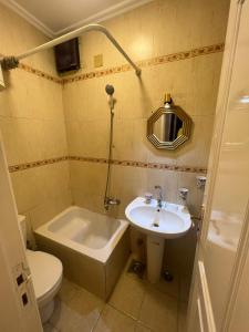 a bathroom with a sink and a tub and a toilet at Cairo in Cairo +28 photos