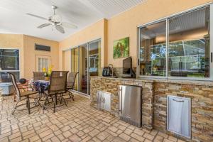 a patio with a table and chairs in a house at Quiet and Cozy 3 beds 3 baths in Spring Hill with heated Pool and Hot Tub in Spring Hill