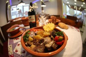 a bowl of food sitting on top of a table at Apartments 43 in Krnjača