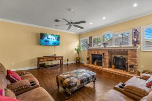 a living room with two couches and a fireplace at Quiet and Cozy 3 beds 3 baths in Spring Hill with heated Pool and Hot Tub in Spring Hill