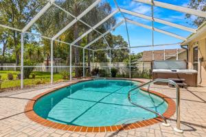 a swimming pool with a pergola next to a house at Quiet and Cozy 3 beds 3 baths in Spring Hill with heated Pool and Hot Tub in Spring Hill