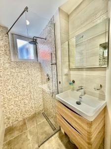 a bathroom with a sink and a shower at Primadonna Apartments in Šibenik