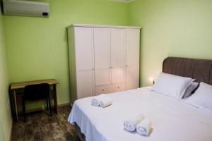 a bedroom with a bed and a desk with a chair at Garden Apartment Fichoza 2 - 80m from the sea in Varna City