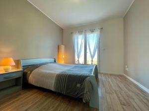 a bedroom with a large bed and a window at Villa des Perdrix - Piscine et Clim - 120m2 in Lavalette +38 photos