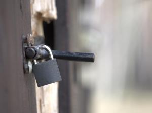 a door with a padlock on the door at Leśna Chata in Bierzów