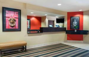 a lobby with a waiting room with red walls at Extended Stay America Suites - Grand Rapids - Kentwood in Grand Rapids