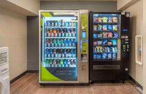 a soda vending machine next to a drink cooler at Extended Stay America Select Suites - Chicago - Westmont - Oak Brook in Westmont