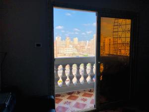 a view of a city from a window of a balcony at Maria Apartment in Alexandria