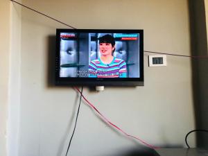 a flat screen tv hanging on a wall at Maria Apartment in Alexandria