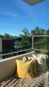 a bed with pillows on top of a balcony at Fornebu Holtekilen panorama in Stabekk