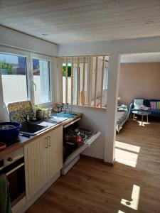 a kitchen with a sink and a counter top at Romanjo in Agon Coutainville +5 photos