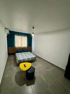 a room with two beds and a table in it at Escapade Panoramique Appt prestige vue mer in Fort-de-France