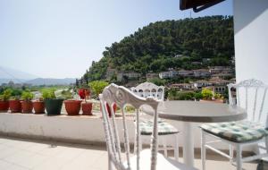 a table and chairs on a balcony with a view at Berat Castle Classic Villa by Lions Gate 1 in Berat